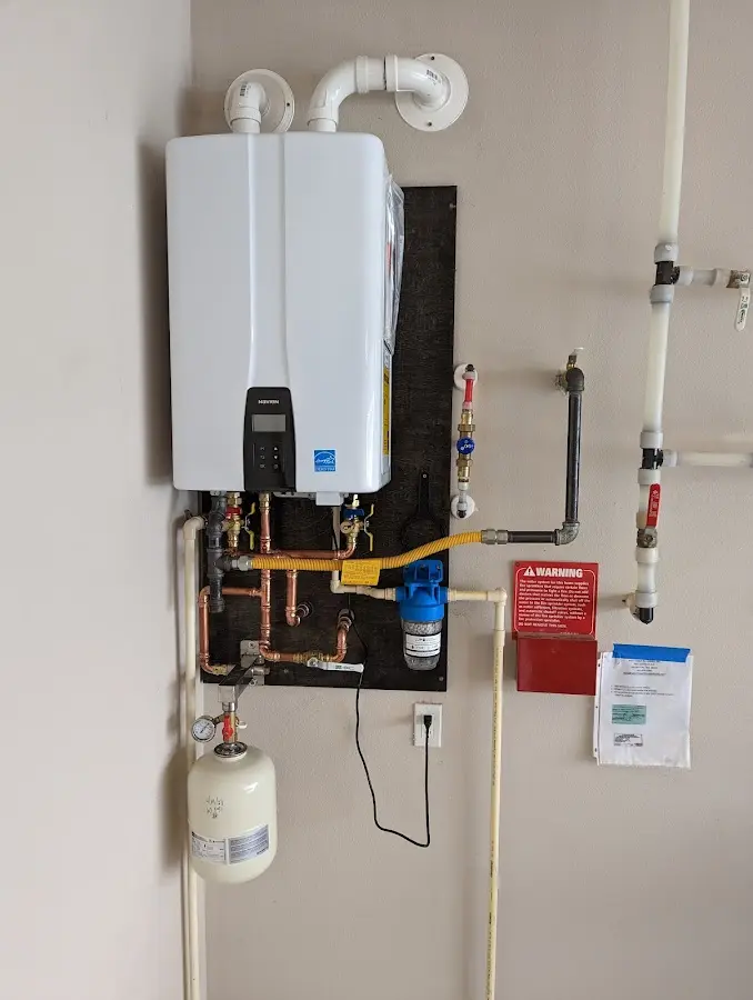 Professional plumber installing copper piping in a Massanetta Springs home